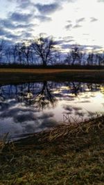 Reflection of trees in lake against sky