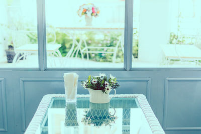 Flowers vase on table against window