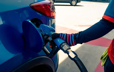 Car fueling at gas station. refuel fill up with petrol gasoline. petrol pump filling fuel nozzle