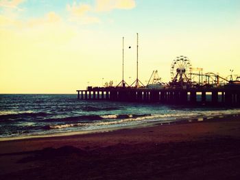 Pier on sea at sunset