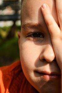 Close-up portrait of boy sitting outdoors