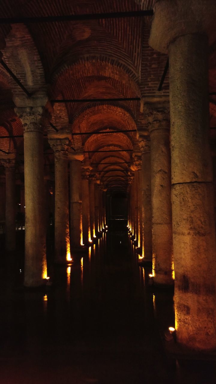 indoors, in a row, architectural column, no people, architecture, arch, illuminated, built structure, travel destinations, place of worship, passage, day