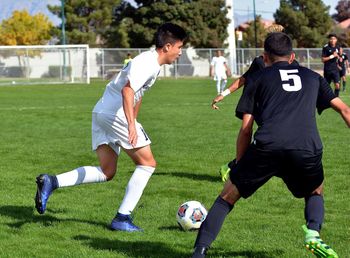 Men playing soccer on field