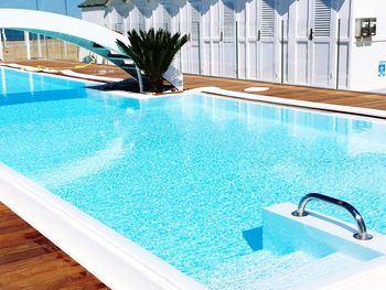 Swimming pool by beach huts at hotel