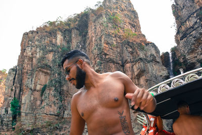 Shirtless bearded young latino at a boat travel on summer vacation in capitólio minas gerais  brazil