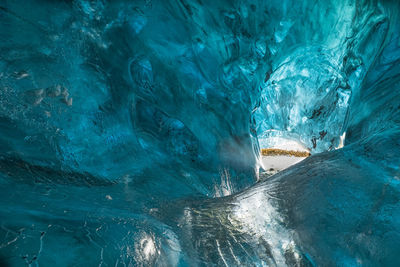 Scenic view of sea seen through cave