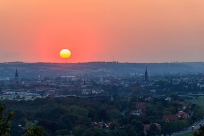 High angle view of townscape against orange sky