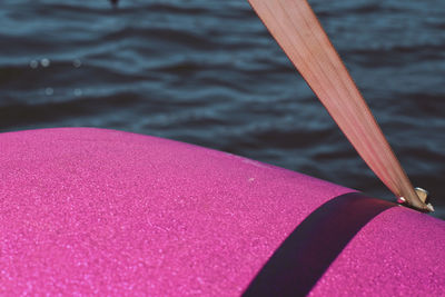 Cropped image of pink pedal boat on sea