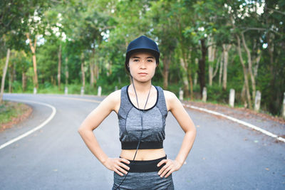 Portrait of sportswoman on road 