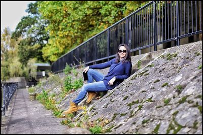 Woman sitting on a tree