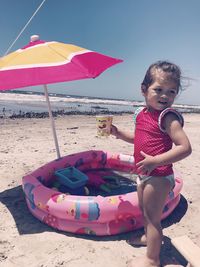 Cute girl sitting on beach