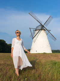 Portrait of woman with umbrella on field