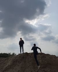 People standing on land against sky