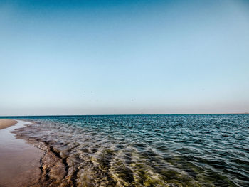 Scenic view of sea against clear blue sky