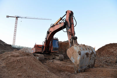 Excavator during earthmoving at construction site. backhoe digg ground at construction site 