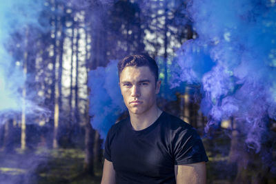 Portrait of young man in forest