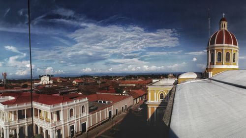View of buildings against cloudy sky