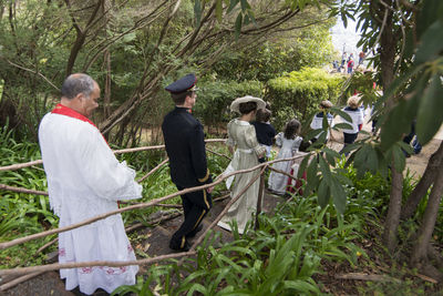 Group of people walking by plants