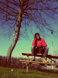 Rear view of man sitting on bench