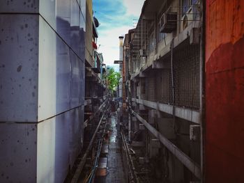 Narrow street amidst buildings in city