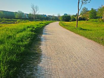 Empty road passing through field