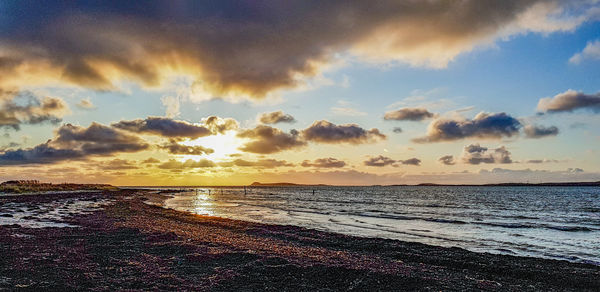 Scenic view of beach against sky during sunset