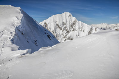 Scenic view of snowcapped mountains against sky
