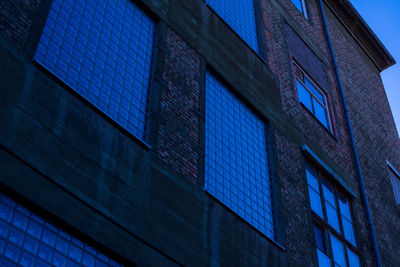 Low angle view of modern building against clear blue sky
