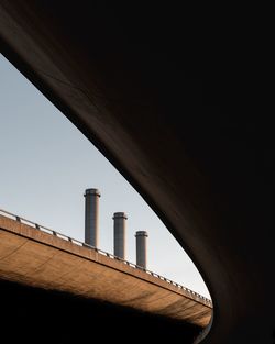 Low angle view of smoke stacks against sky