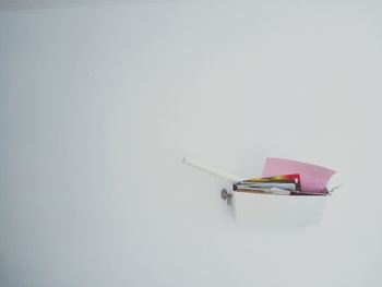 High angle view of book on table against white background