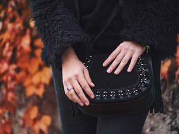 Close-up midsection of woman holding bag