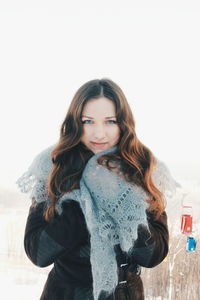 Portrait of woman standing against sky during winter