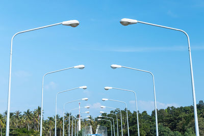 Low angle view of electricity pylon against clear sky