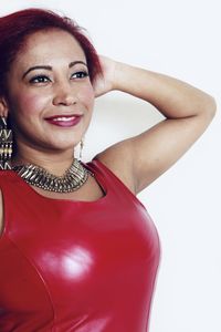 Portrait of a smiling young woman against white background