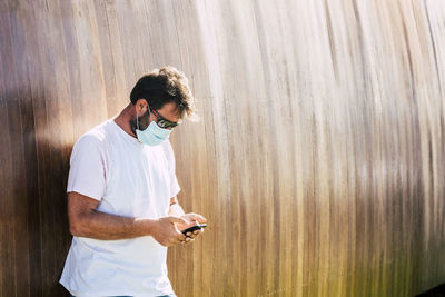 Full length of man using mobile phone