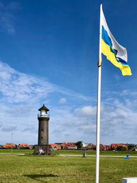 Flag on field against sky