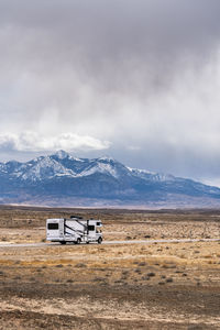 From above caravan in road trip in breathtaking scenery of rocky formations in highlands in mount pennell near factory butte in utah, usa