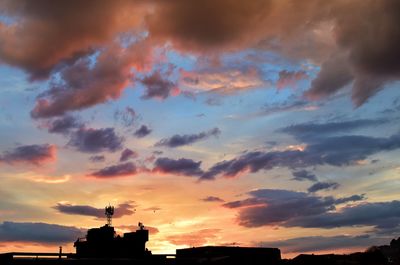 Low angle view of silhouette statue against sky during sunset