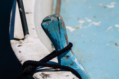 Close-up of blue boat on pier