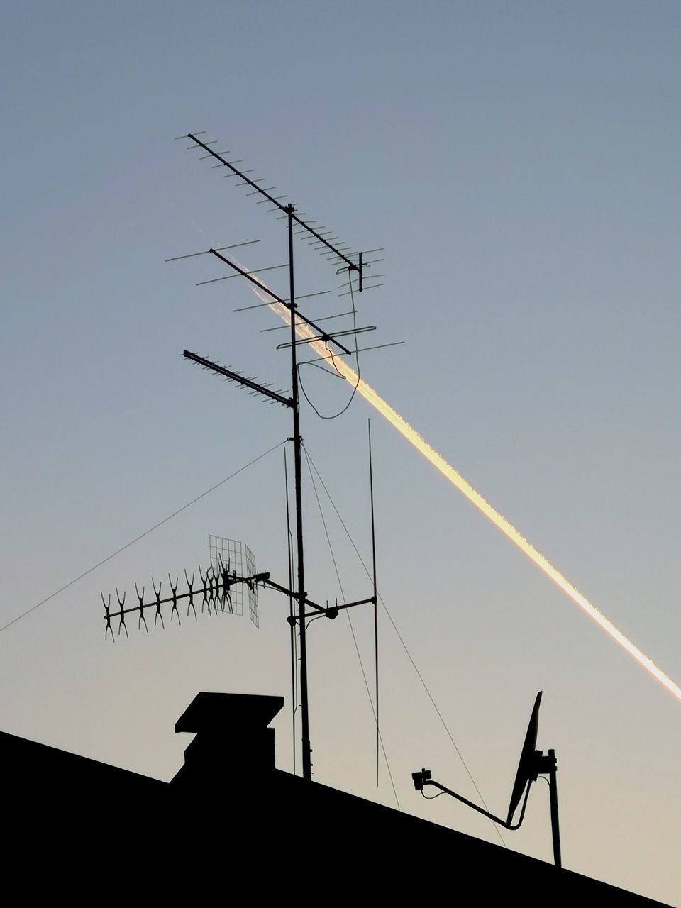 LOW ANGLE VIEW OF SILHOUETTE TELEPHONE POLE AGAINST CLEAR SKY