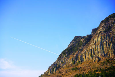 Low angle view of vapor trail against blue sky