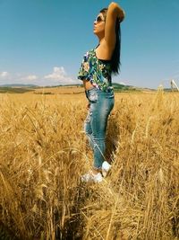 Woman standing on field against clear sky