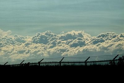 Scenic view of landscape against cloudy sky