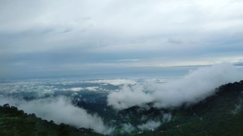 Scenic view of foggy weather against sky