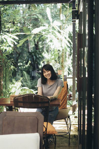 Portrait of young woman sitting on chair