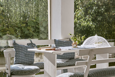 Empty chairs and table in yard