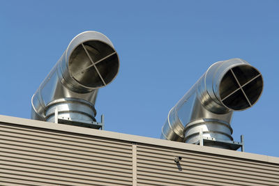 Low angle view of communications tower against sky