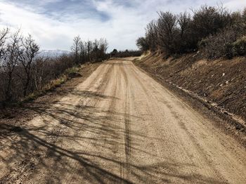 Empty road along countryside landscape