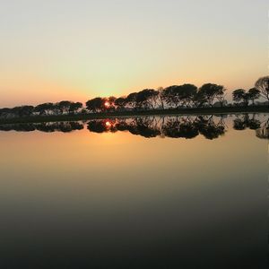 Scenic view of lake at sunset