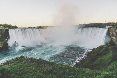 Scenic view of waterfall against sky